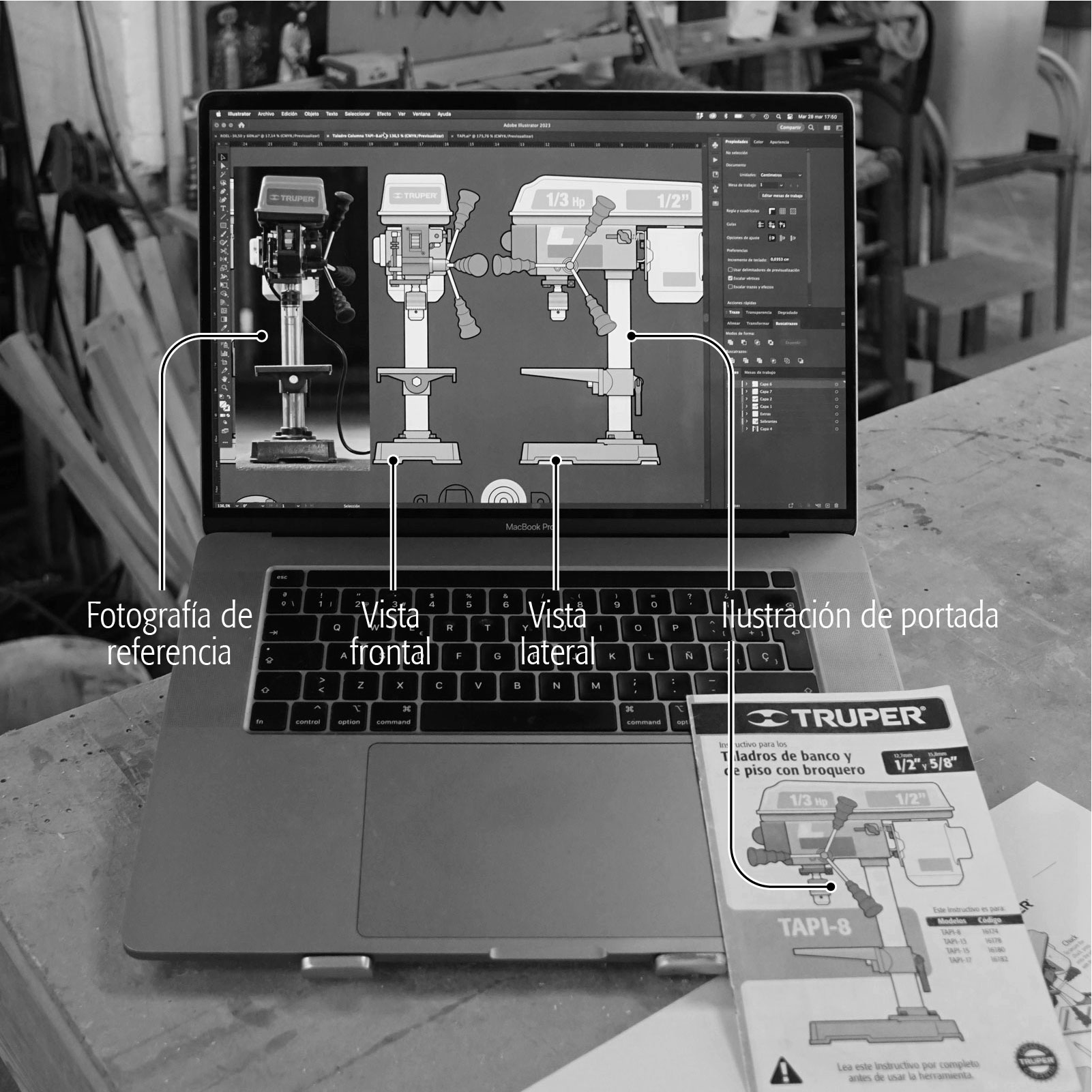 MacBook en un taller de carpintería con un manual de instrucciones Truper sobre el teclado. En la pantalla del laptop se puede ver el archivo abierto de una de las ilustraciones del manual: un taladro de banco hecho en Adobe Illustrator.